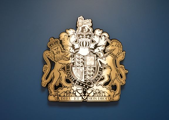 Royal Coat of arms on a blue feature wall at the Coroner's Court. 